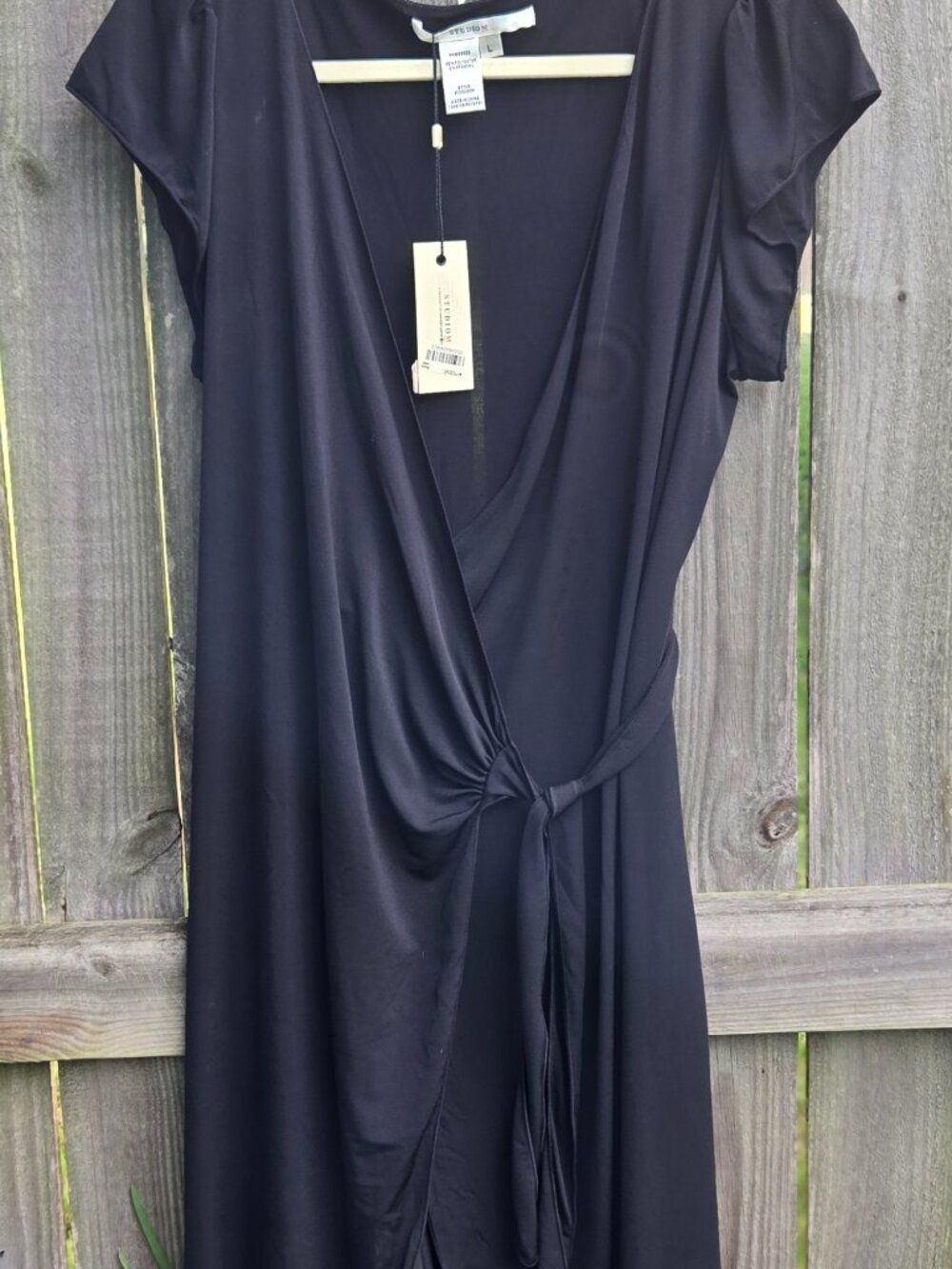 Understated & sexy. Black dress goes from office - party. Comfy tie front vneck